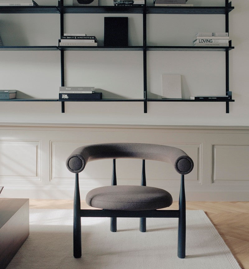 Modern chair in a room with glass shelves and decor